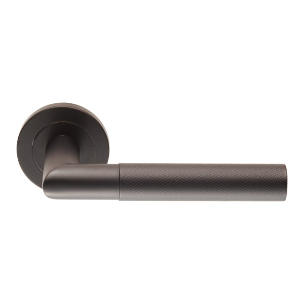 Carlisle Brass Crown Knurled Lever in a matte black finish with a cylindrical grip featuring a knurled texture, mounted on a round rose base.