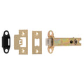 Carlisle Brass Easi-T Heavy Sprung Tubular Latch in a gold finish, shown with one black strike plate and two brass faceplates, featuring a tubular design and internal mechanism for secure door closure.