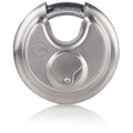 Carlisle Brass Laminated & Weatherproof Padlock featuring a hardened steel body with a metallic silver finish and a circular design. The padlock includes a side-locking mechanism for added security.