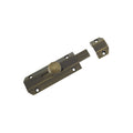 Zoo Hardware Surface Bolt 102mm in antique brass finish, featuring a round thumb turn and a sliding bolt mechanism. The design includes pre-drilled holes for easy installation.